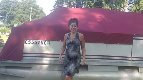 a smiling lady wearing western standing